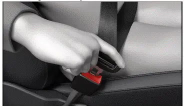 Fig. 1 Inserting the buckle tongue into the safety belt buckle (general example).